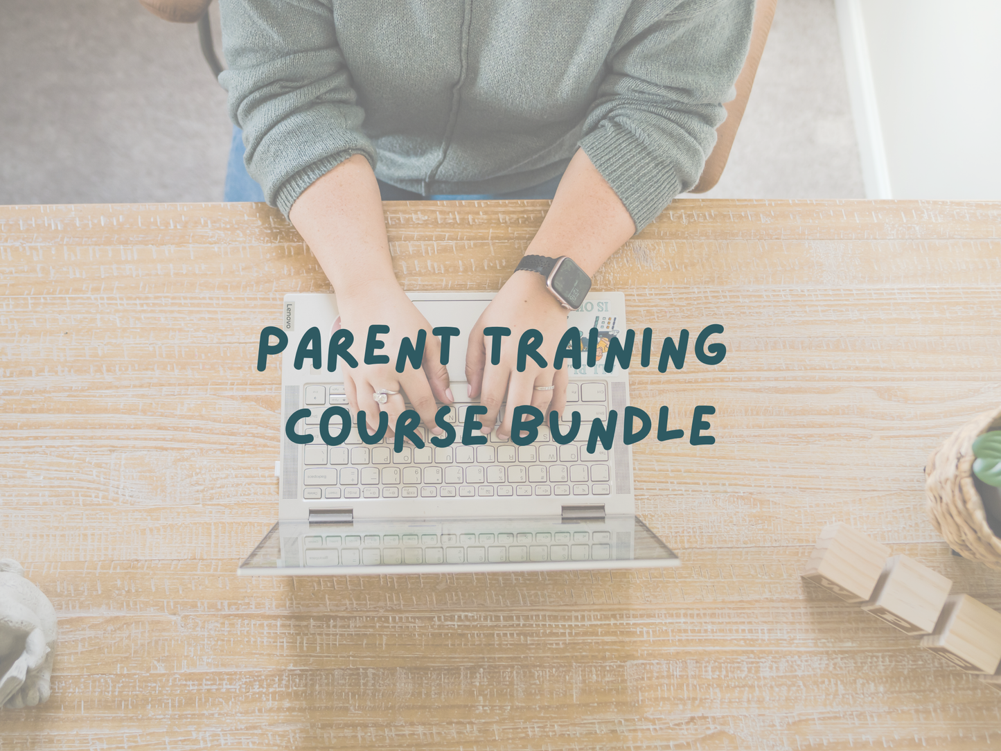 Person using a laptop with 'Parent Training Course Bundle' text on a wooden table.